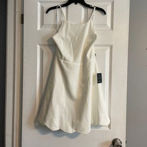 White dress with scalloped hem